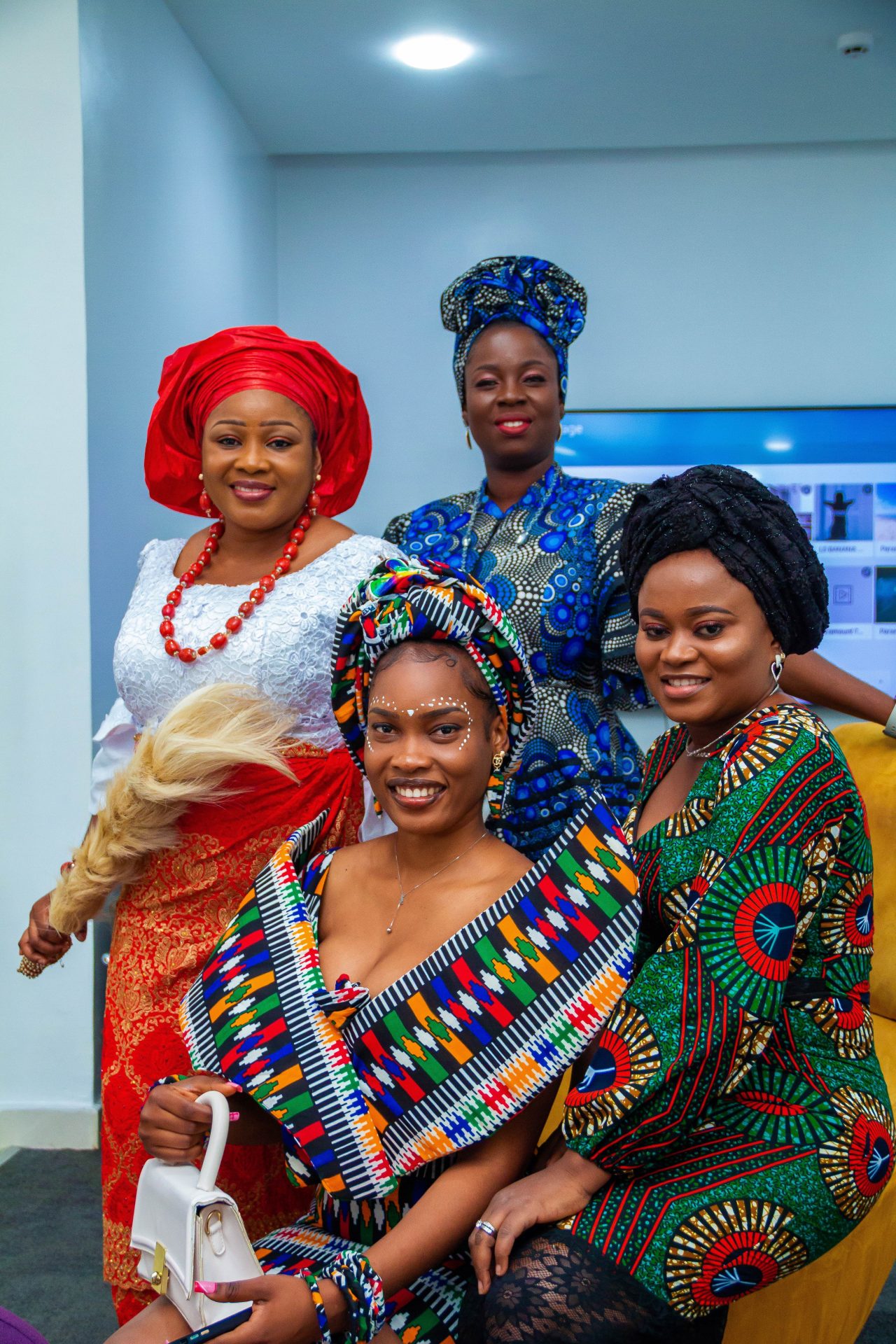 A close-up photo of four black women in African attire